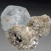 Beryl v. Aquamarine on Muscovite w. unknown
