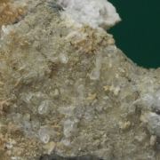 Monteregianite-(Y) (type locality) with Pectolite on Albite