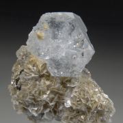 Beryl v. Aquamarine on Muscovite w. unknown