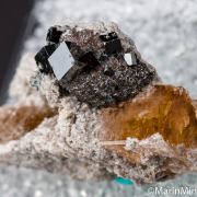 Bixbyite on Hematite after Garnet on Topaz