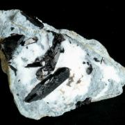 Neptunite on Natrolite