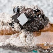 Bixbyite on Hematite after Garnet on Topaz
