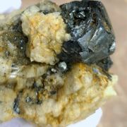Hematite ( var. Eisenrose ) on Adularia with Rutile and Quartz