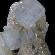 Beryl (elongated crystals) on Muscovite