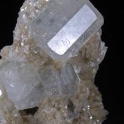 Beryl (elongated crystals) on Muscovite