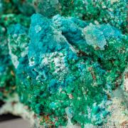 Cuprian Adamite, Rosasite, Smithsonite, Malachite on Calcite casts
