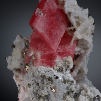 Rhodochrosite- sharp rhombs with Quartz, Pyrite and Calcite