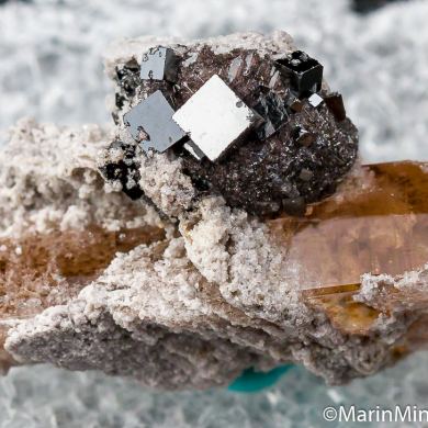 Bixbyite on Hematite after Garnet on Topaz